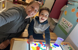 Child playing with light and letter toys