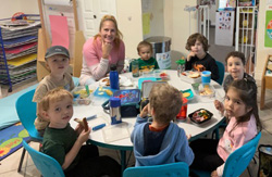 Kids gathered around table sharing stories