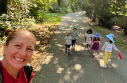Group walking through forest trail